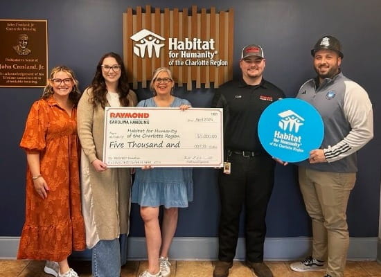 Carolina Handling associates present a $5,000 check to Habitat for Humanity of the Charlotte Region 