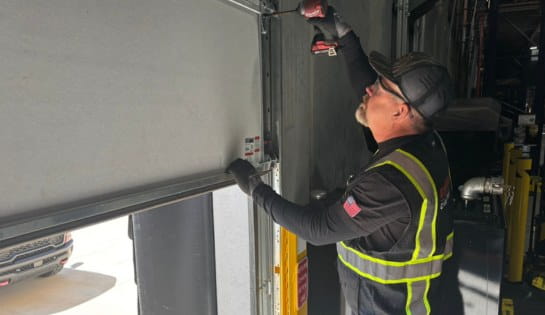 Tech installing new dock door.